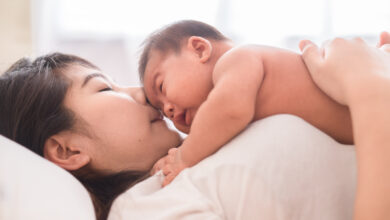 Happy mother holding adorable child baby boy