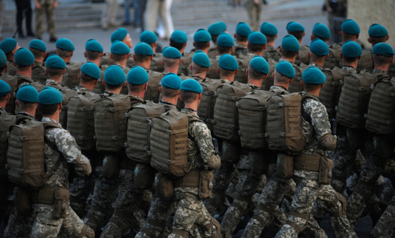 Soldiers paratroopers marching on square during military parade