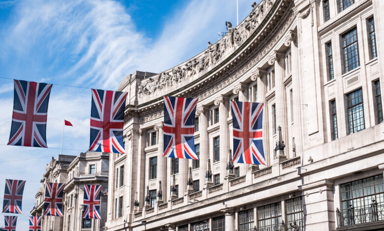 Close up of buildings on Regent Street London UK photographed from street level, with row of British flags to celebrate the Royal Wedding of Prince Harry to Meghan Markle.