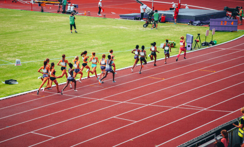 Female track and field race at athletics stadium. Professional female runners. Photo for athletics competition at summer olympic game Tokyo 2020.