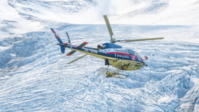 MATREI IN OSTTIROL, AUSTRIA - AUGUST 21, 2021: Austrian Police Air Support Helicopter - Eurocopter AS 350B Ecureuil. Montain glacier on background. Austria