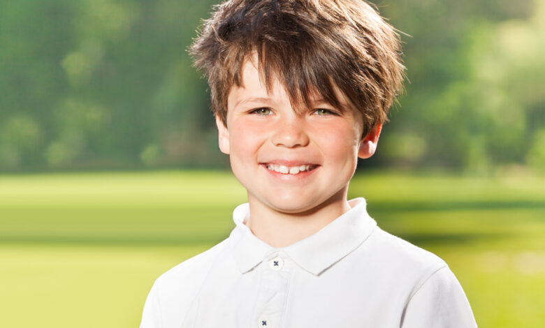 Outdoor portrait of joyful ten years old boy