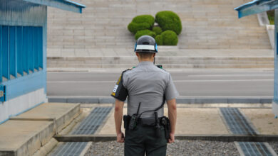 PANMUNJOM, SOUTH KOREA - SEPTEMBER 26, 2014: Korean soldiers watching border between South and North Korea in the Joint Security Area (DMZ) on September 26, 2014 in Panmunjom, South Korea.