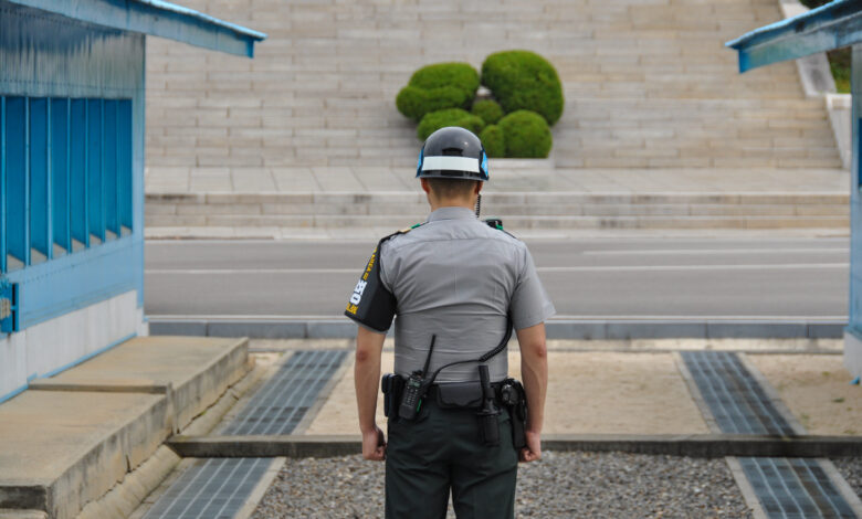 PANMUNJOM, SOUTH KOREA - SEPTEMBER 26, 2014: Korean soldiers watching border between South and North Korea in the Joint Security Area (DMZ) on September 26, 2014 in Panmunjom, South Korea.