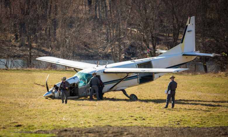 Crashed plane on field with police investigating