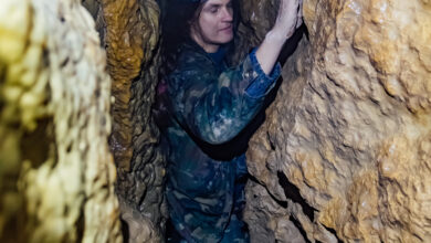 Man explores narrow cave