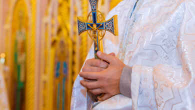 Orthodox priest holds with a cross in his hands