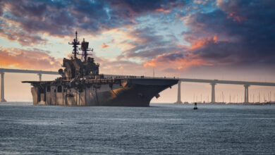 A US Navy ship departs San Diego Bay for the Pacific Ocean.