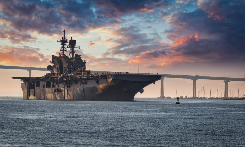 A US Navy ship departs San Diego Bay for the Pacific Ocean.