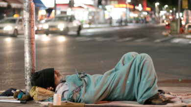 male homeless sleeping in a street