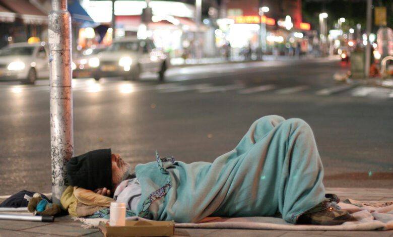 male homeless sleeping in a street