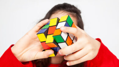 Portrait of the girl with a Rubik's cube. Close up