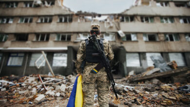 Ukrainian military woman with the Ukrainian flag in her hands on