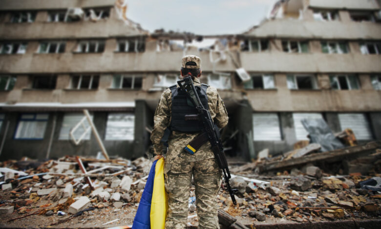 Ukrainian military woman with the Ukrainian flag in her hands on