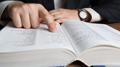 man looking in the large dictionary